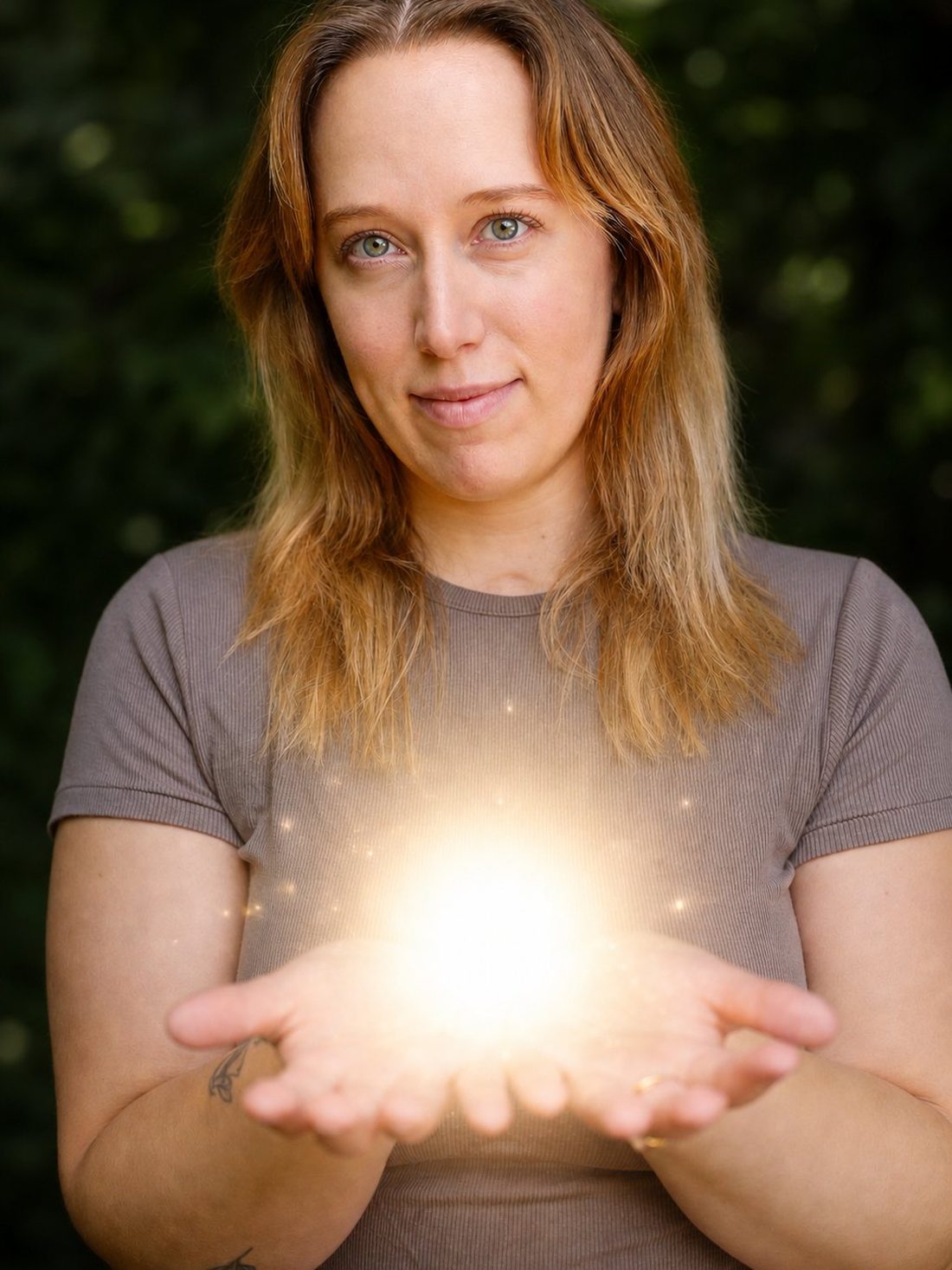 Samantha holding her hands cupped together in soft natural light.