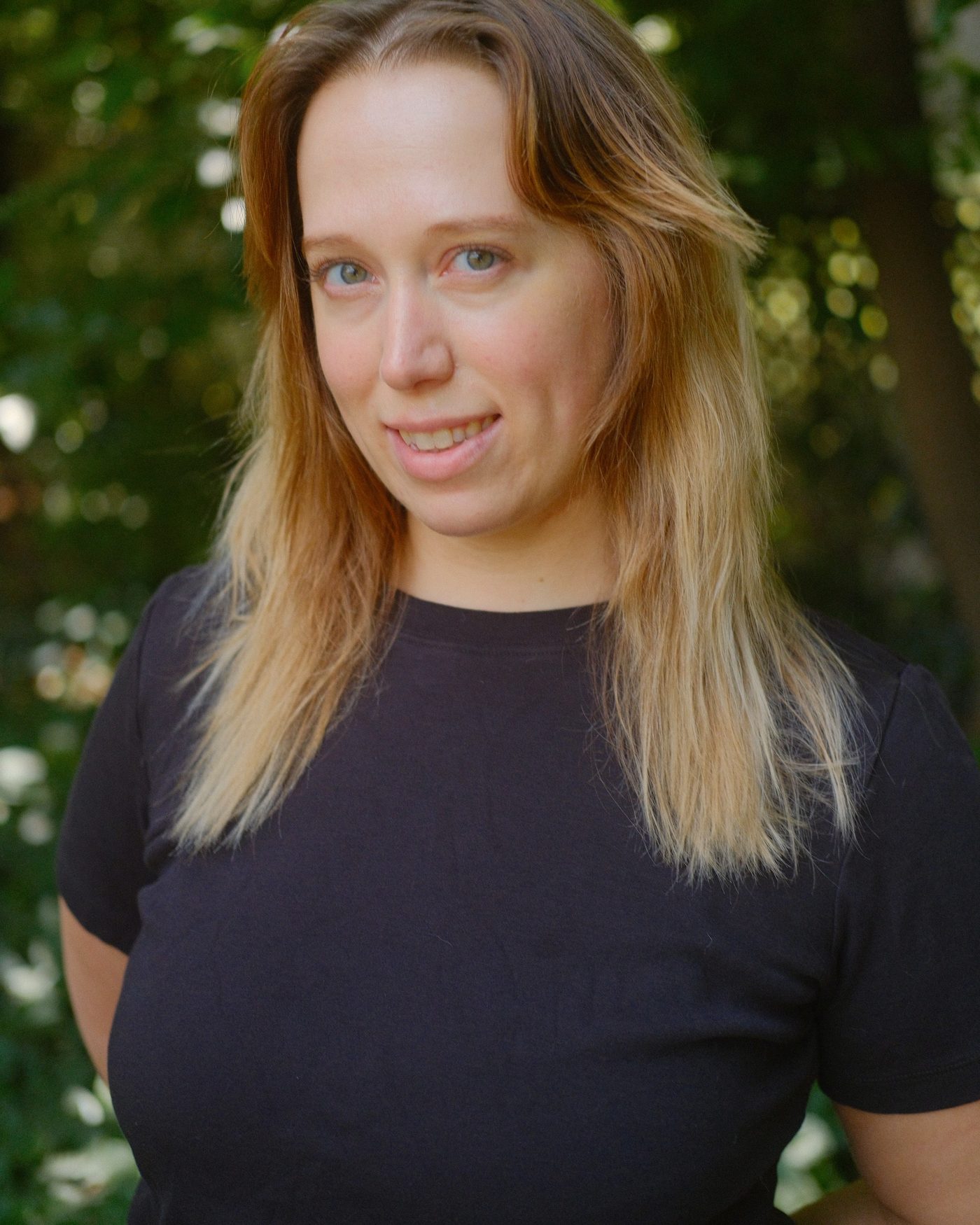 Samantha Campbell, licensed massage therapist and founder of Luma Therapeutic Bodywork. Photographed outside in soft natural light.